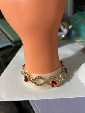 Gold-Tone Infinity Bracelet with Red Ladybug Accents